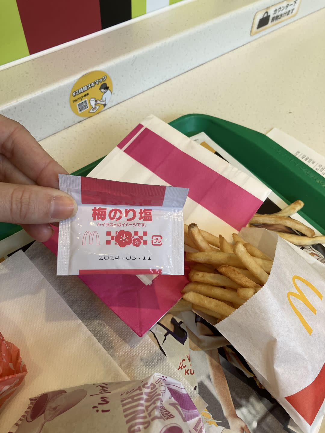 a hand holding a box of french fries