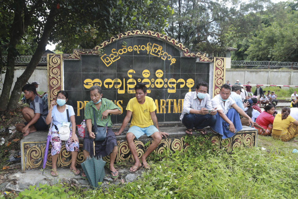 Family members and friends wait to welcome released prisoners outside the Insein Prison Tuesday, Oct. 19, 2021, in Yangon, Myanmar. Myanmar's government on Monday announced an amnesty for thousands of prisoners arrested for taking part in anti-government activities following February's seizure of power by the military. (AP Photo)