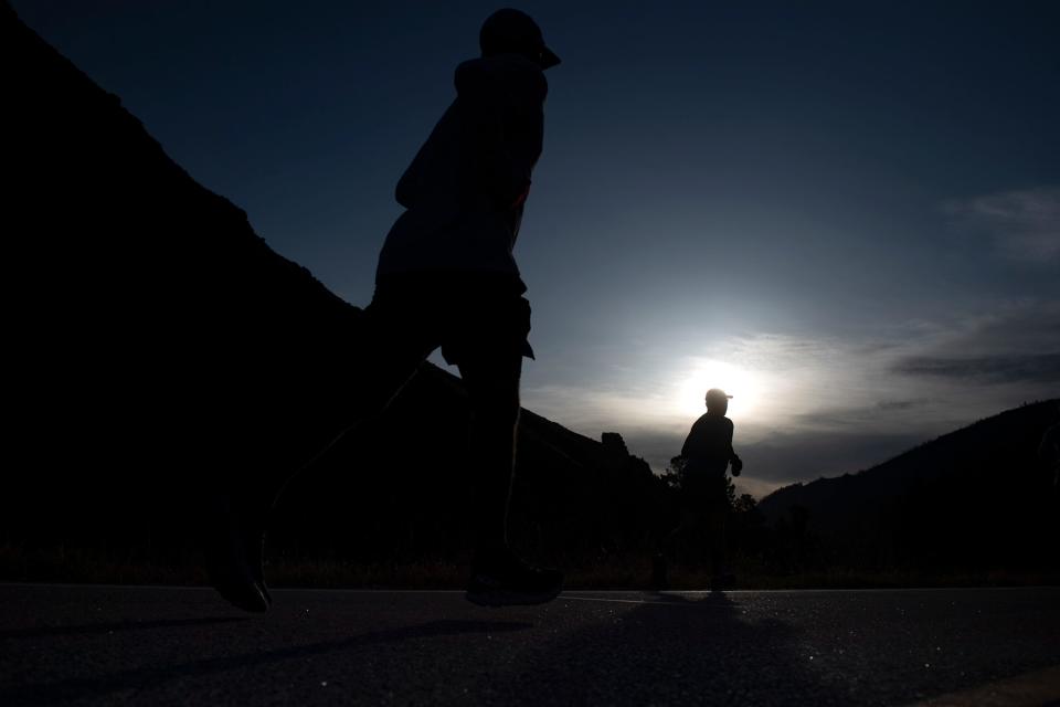 Colorado Marathon runners make their way down the Poudre Canyon on Sunday.