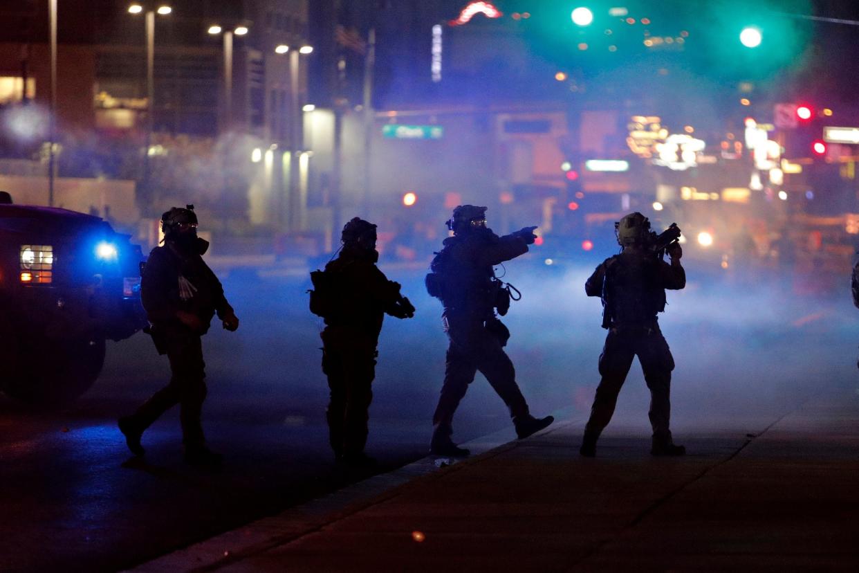 Las Vegas police walk through tear gas during a protest after the death of George Floyd: AP