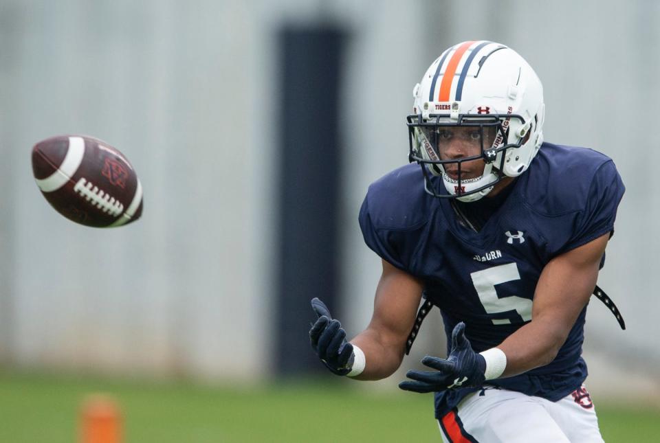 Auburn Tigers wide receiver Jay Fair (5) catches a pass during Auburn Tigers football practice at the Woltosz Football Performance Center at in Auburn, Ala., on Monday, April 3, 2023. 