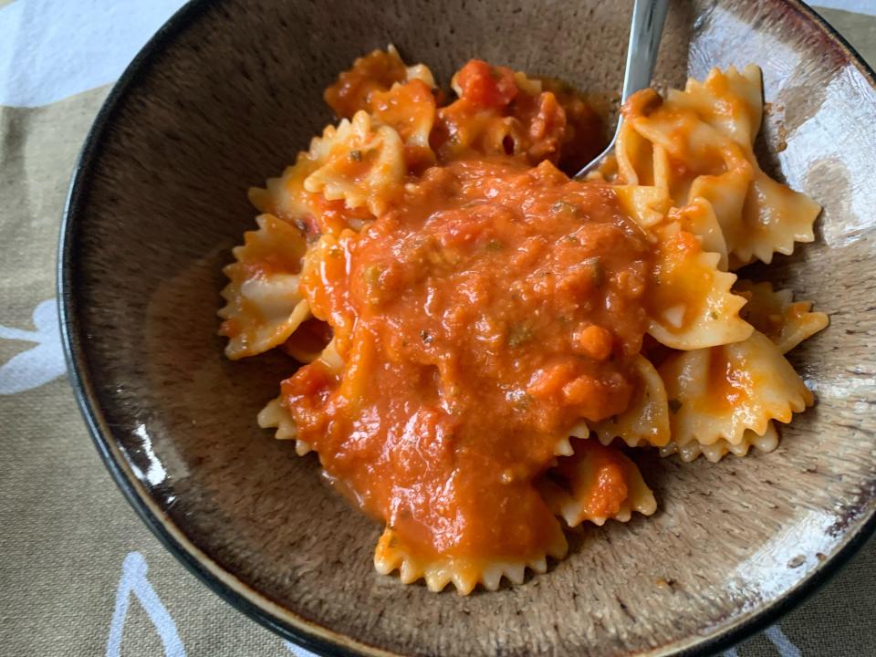 A bowl of farfalle pasta covered in Trader Joe's creamy tomato-basil sauce