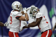 East running back Benny LeMay, of Charlotte, right, celebrates his touchdown against the West with tight end Mitchell Wilcox, of South Florida, (89) during the second half of the East West Shrine football game Saturday, Jan. 18, 2020, in St. Petersburg, Fla. (AP Photo/Chris O'Meara)