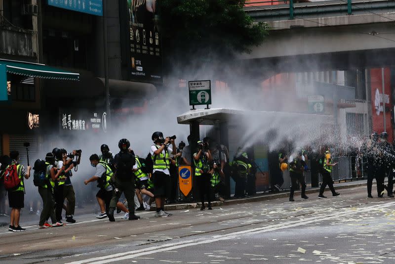 Riot police use water cannon to disperse anti-national security law protesters during a march at the anniversary of Hong Kong's handover to China from Britain in Hong Kong