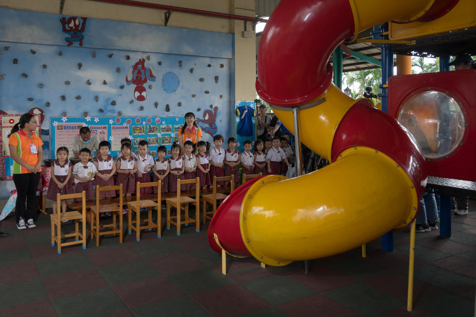 Kindergarten students welcome the President during an Oct. 5 visit. | Billy H.C. Kwok for TIME