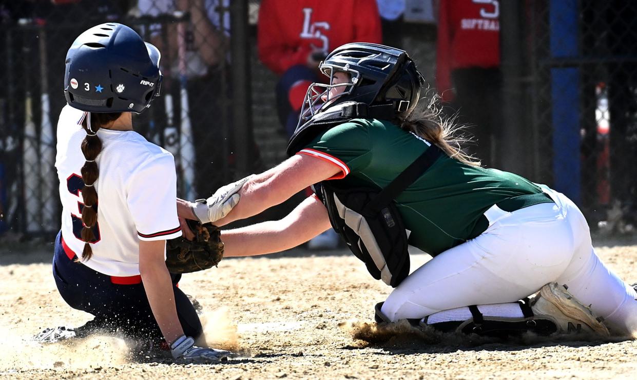 Hopkinton catcher Zoe Adams tags out Lincoln-Sudbury's Grace Jorjorian in the third inning of a non-league game at Lincoln-Sudbury High School, April 22, 2022.  