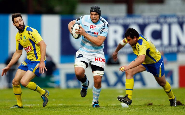 Racing-Metro's lock Francois Van Der Merwe (C) runs with the ball during a French Top 14 rugby union match against Clermont on April 19, 2014, at the Yves du manoir Stadium, in Colombes, near Paris