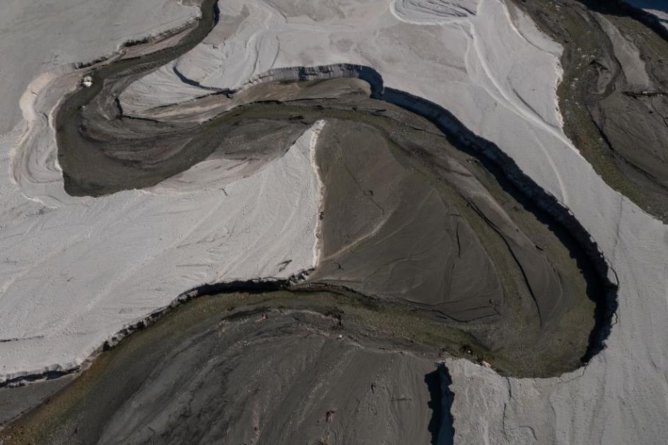 The San Gabriel River and the exposed lakebed of the San Gabriel Reservoir are seen in the third week of spring as another year of drought develops throughout the west, on April 8, 2021 in the San Gabriel Mountains near Azusa, California.