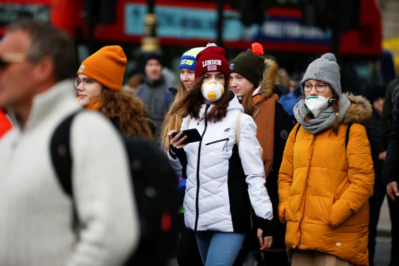 People are pictured wearing protective face masks in London