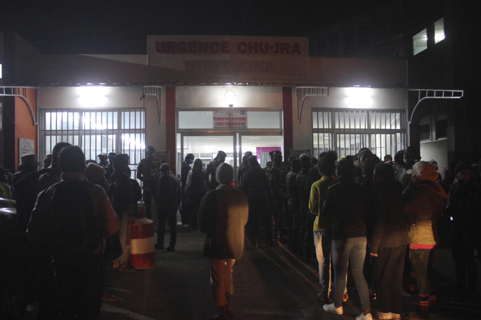 People gather outside the HJRA hospital, in Antananarivo. Madagascar, Friday Aug.25, 2023, to find out situation of loved ones after a crush at a local stadium. Local media in Madagascar report that at least 12 people have died in a crush at the stadium as sports fans gathered for the opening ceremony of the Indian Ocean Island Games.(AP Photo Laetitia Bezain)