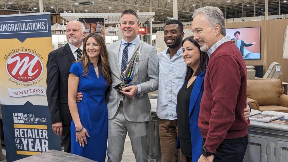 Pictured left to right: Lynwood Mueller, Viviana Mueller, Mark Mueller, “Show Me St. Louis” personality Malik Wilson, and Shannon Williams and Mark Schumacher of the Home Furnishings Association