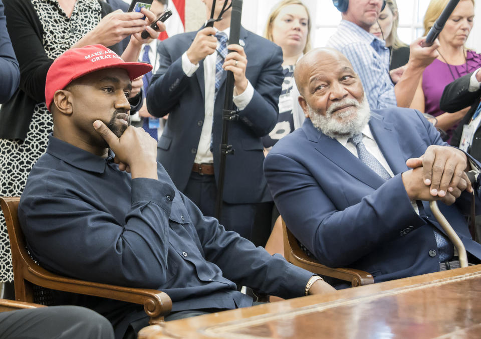 View of American rapper and producer Kanye West (left) and retired professional football player Jim Brown, in the White House’s Oval Office, Washington DC, October 11, 2018. West wears a red baseball cap that reads ‘Make America Great Again.’ (Photo by Ron Sachs/Consolidated News Pictures/Getty Images)