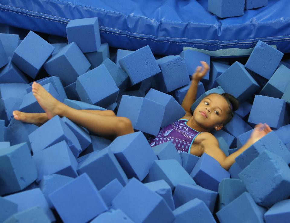 Delilah McDaniels, 8, lands in a foam pit after practice on a tumble track at First State Gymnastics on Sept. 9, 2022.