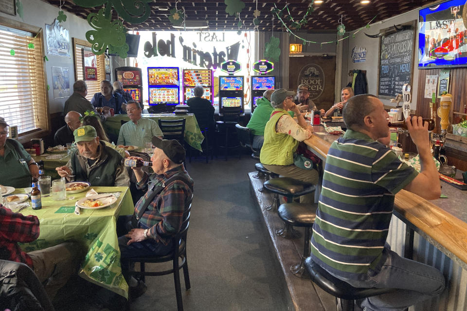 The lunchtime crowd enjoys food and beer on March 17, 2023, at the Last Waterin' Hole restaurant in North Plains, Ore. The farming community is on tap to undergo changes if the state is able to attract semiconductor businesses nearby. Intel already has a large facility in the nearby city of Hillsboro, Oregon, and is the state's largest corporate employer. (AP Photo/Andrew Selsky)