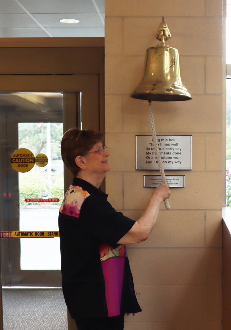 Alicia Weaver, a cancer patient at Lewis Cancer Research Pavilion, rings the survivor's bell. She volunteered for a clinical trail because she's a "people lover".