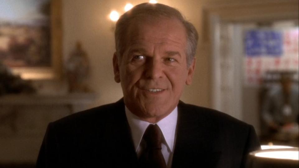 Leo McGarry (John Spencer) smiles on The West Wing.