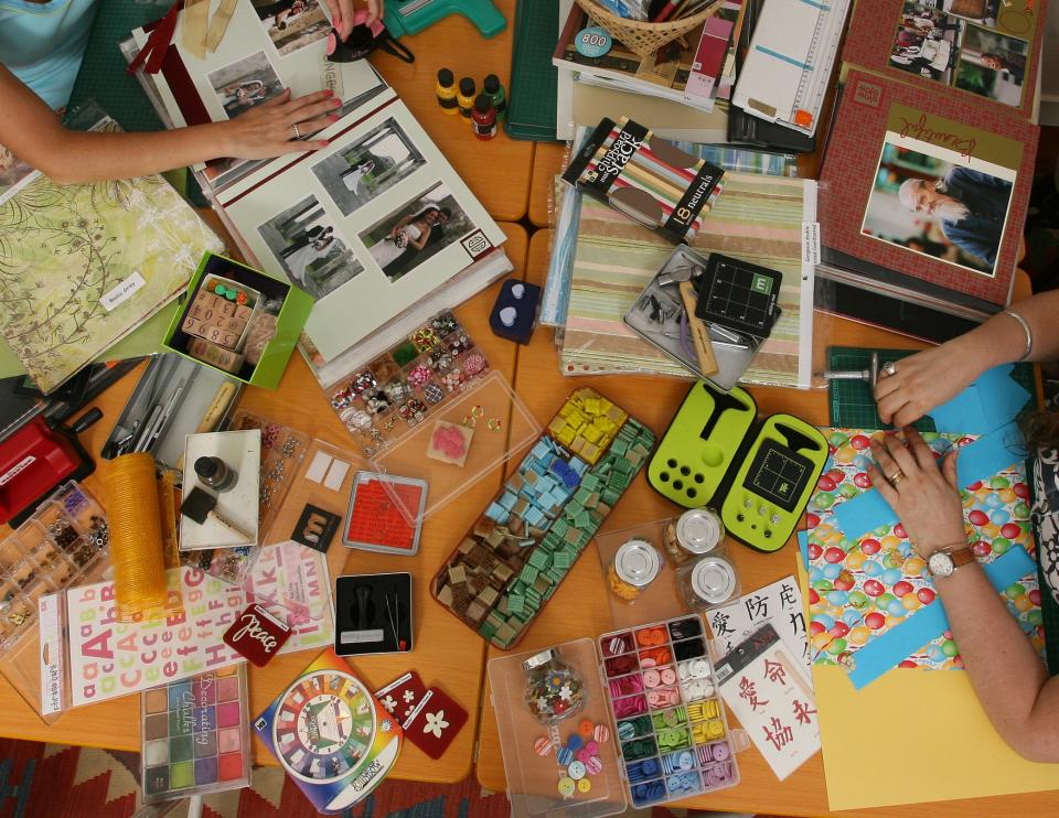 people scrapbooking on a table