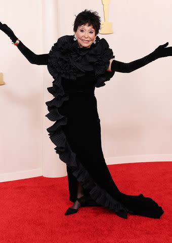 <p>Kevin Mazur/Getty</p> Rita Moreno wears dramatic all-black look with major hair change at the 2024 Oscars