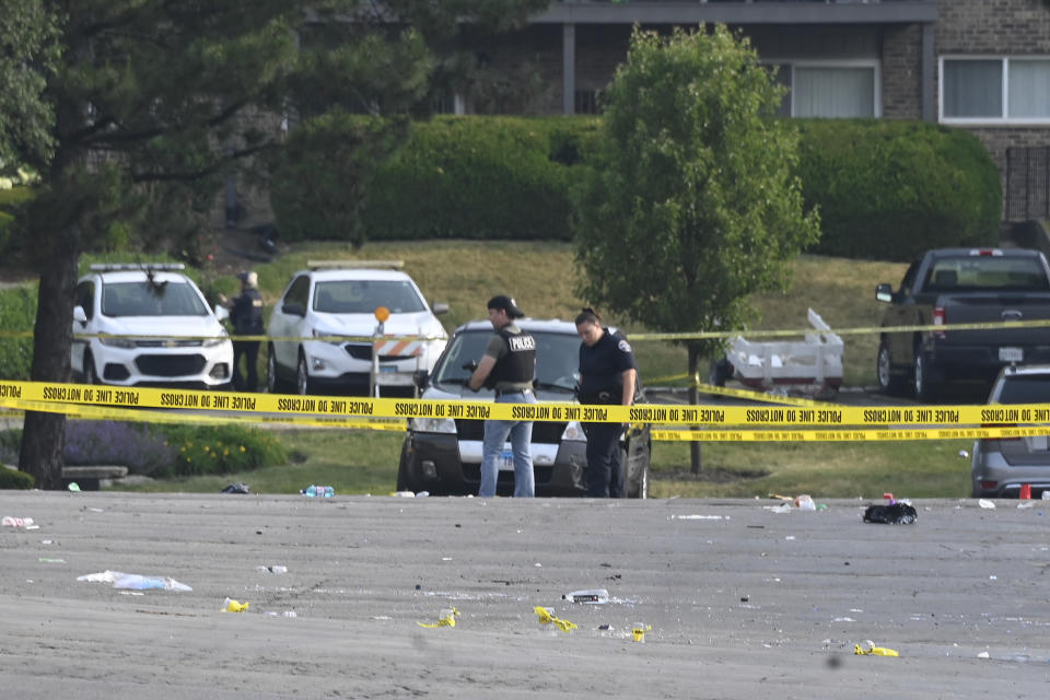 Investigators look over the scene of an overnight mass shooting at a strip mall in Willowbrook, Ill., Sunday, June 18, 2023. (AP Photo/Matt Marton)