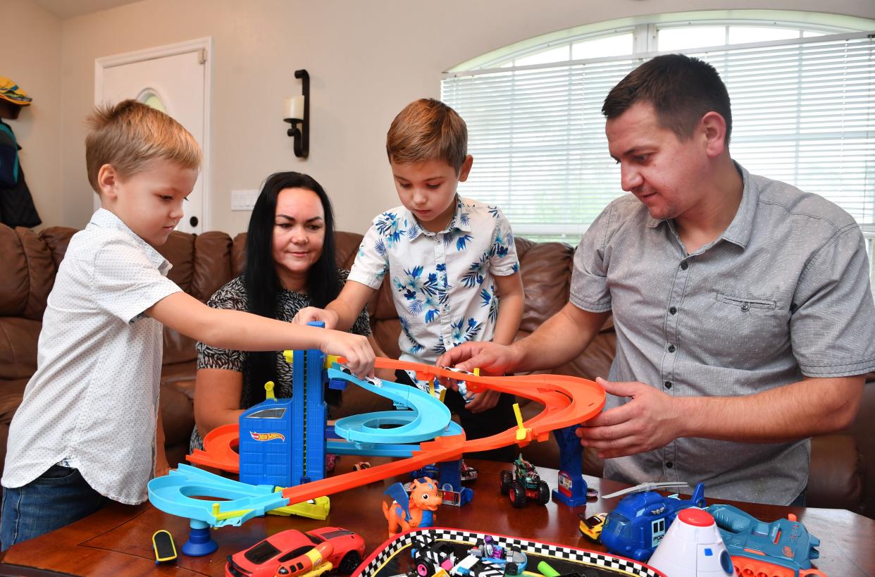 Maryna and Volodymyr Pavlenko with their children, Nikita, 5, left, and Pavlo, 8, at their home in North Port.  The family fled their home in Ukraine after the Russian invasion. 