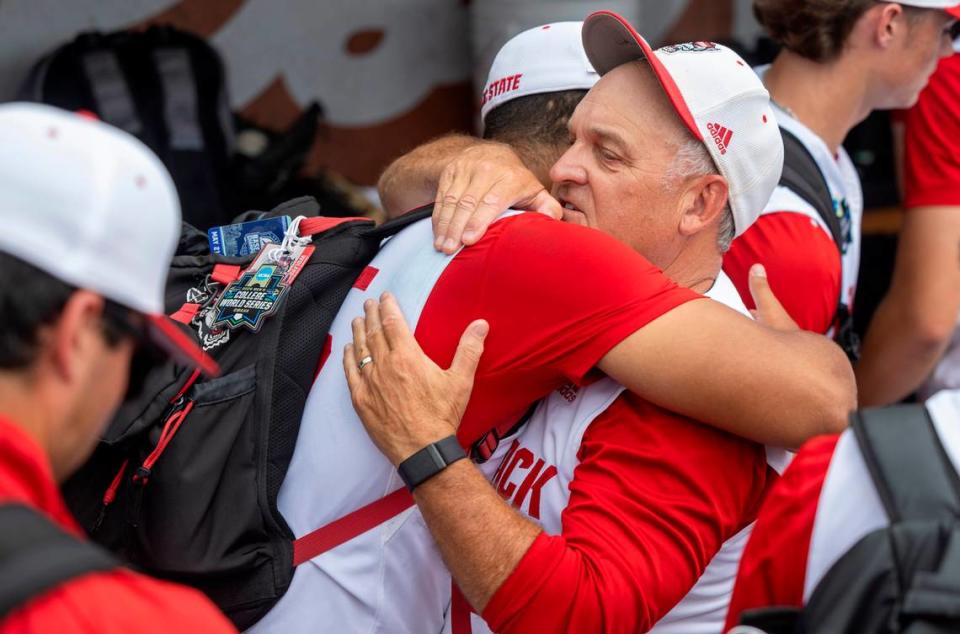 N.C. State coach Elliott Avent embraces pitcher Derrick Smith (25) following the Wolfpack’s 5-4 season ending loss to Florida in game seven of the College World Series on Monday, June 17, 2024 at Charles Schwab Field in Omaha, Nebraska.