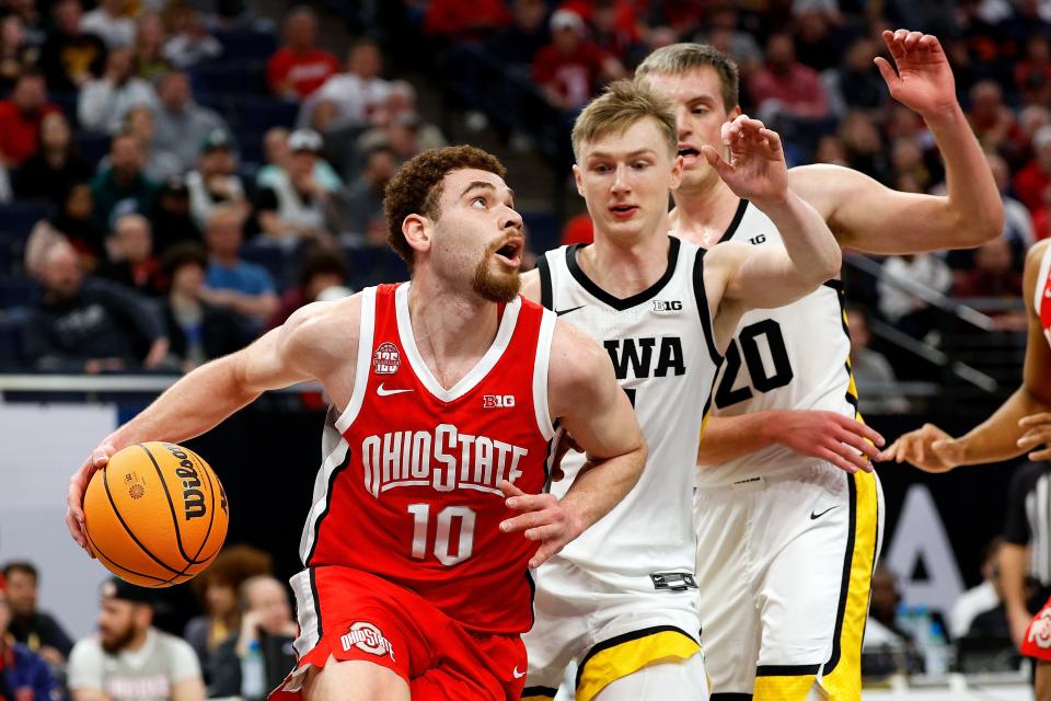 MINNEAPOLIS, MINNESOTA - MARCH 14: Jamison Battle #10 of the Ohio State Buckeyes goes to the basket against Josh Dix #4 of the Iowa Hawkeyes in the second half in the Second Round of the Big Ten Tournament at Target Center on March 14, 2024 in Minneapolis, Minnesota. The Buckeyes defeated the Hawkeyes 90-78. (Photo by David Berding/Getty Images)