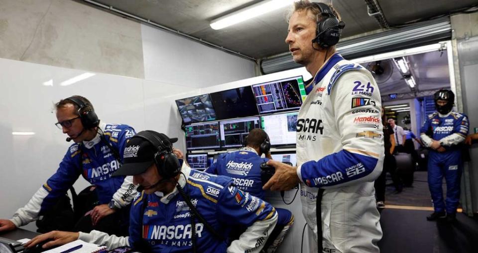 Jenson Button checks out the monitors in the Garage 56 paddock