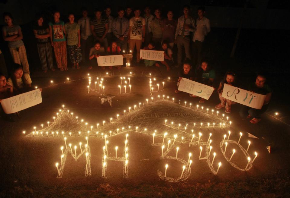 Students take part in a tribute to the passengers and crew onboard the missing Malaysian Airlines flight MH370, in Agartala