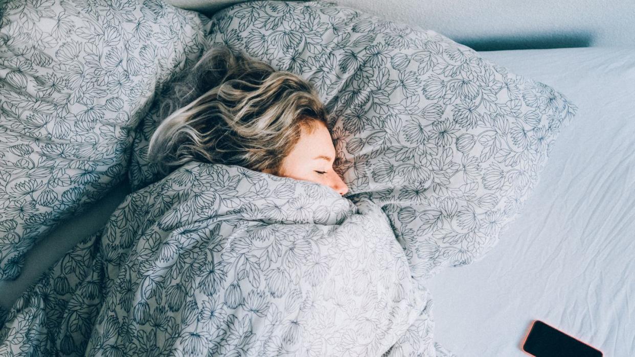 high angle view vie of woman sleeping on bed