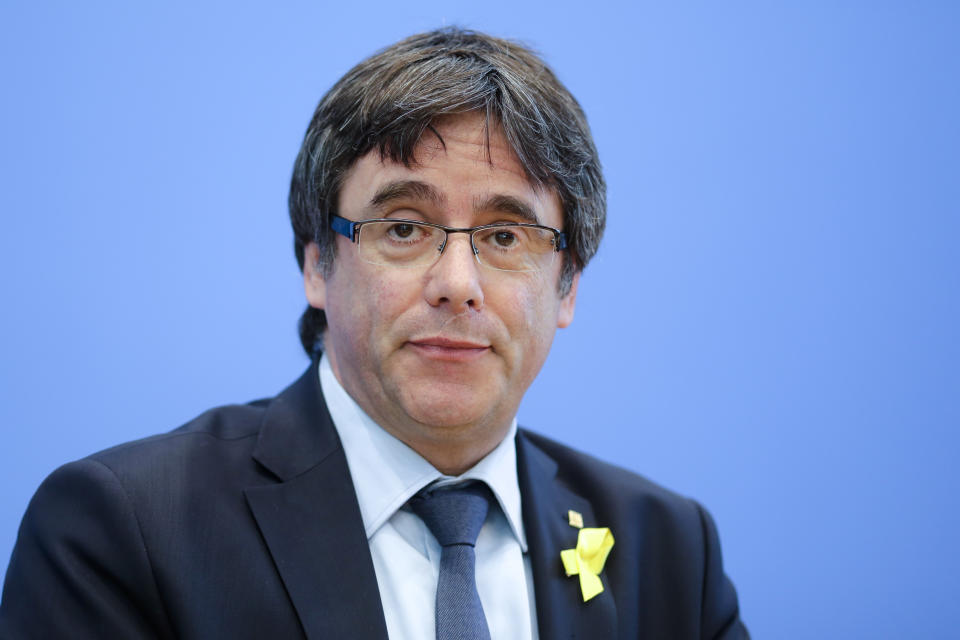 Former Catalan leader Carles Puigdemont, center, addresses the media during a news conference in Berlin, Germany, Wednesday, July 25, 2018. (AP Photo/Markus Schreiber)