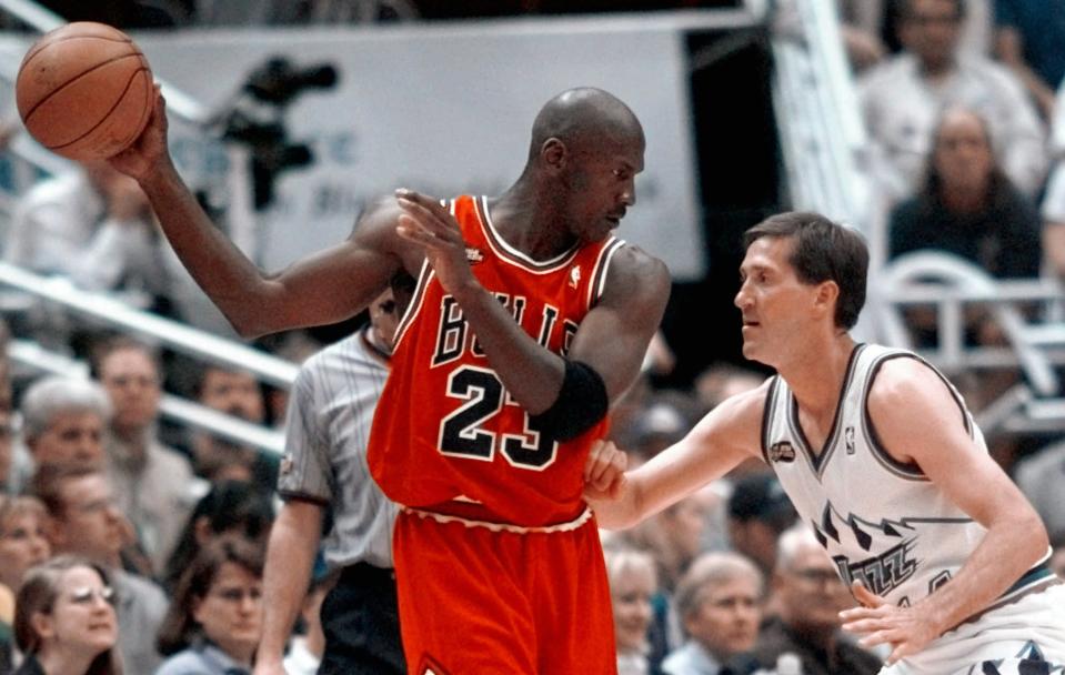 Chicago Bulls' Michael Jordan pulls the ball out of reach of Utah Jazz guard Jeff Hornacek, right, during third quarter action in Game 2 of the NBA Finals in Salt Lake City, Friday, June 5, 1998. (AP Photo/Mark J. Terrill)