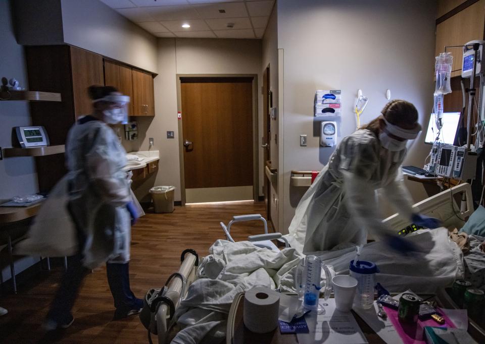 Nurses Emily Owen and Stephenie Simmons check on a COVID-19 patient.