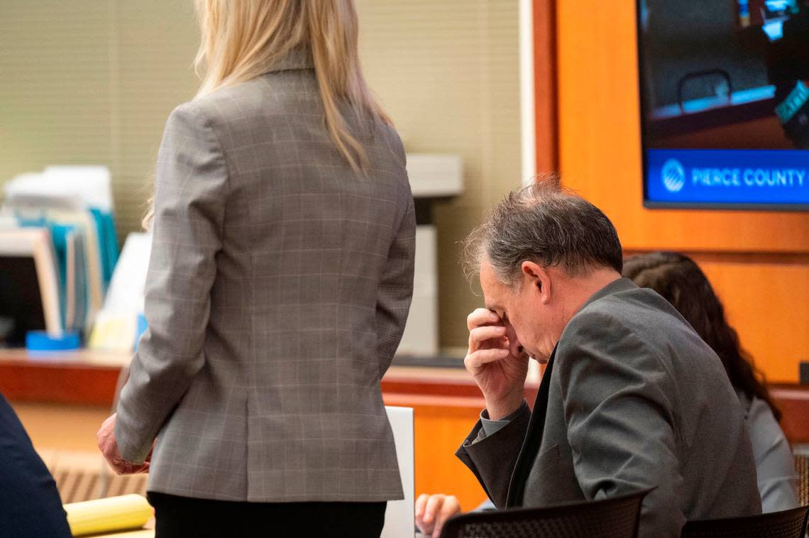 Pierce County Sheriff Ed Troyer scratches his face while his defense attorney, Anne Bremner, addresses the court on Monday, Dec. 12, 2022, in Pierce County District Court in Tacoma.