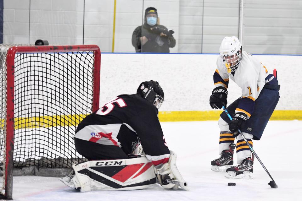 Northern Highlands hockey vs. Ramsey in the Ice Vault Tournament championship game on Friday, March 5, 2021. R #7 Justin Bello and NH goalie #35 Daniel Moor.