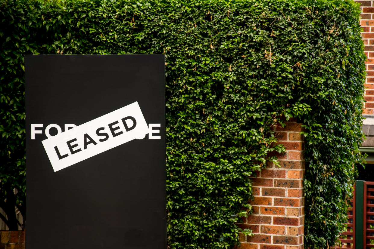 For lease and leased sign outside a residential building for rent.