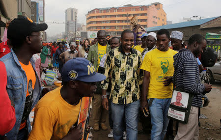 Kenyan social-political activist Boniface Mwangi (C) is escorted by supporters during his political campaign ahead of the August elections along the streets of downtown Nairobi, Kenya, May 31, 2017. Picture taken May 31, 2017. REUTERS/Thomas Mukoya