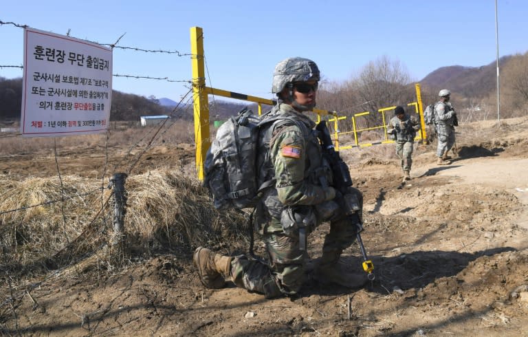 US soldiers take a position during their drill at a military training field in Paju, on March 7, 2017