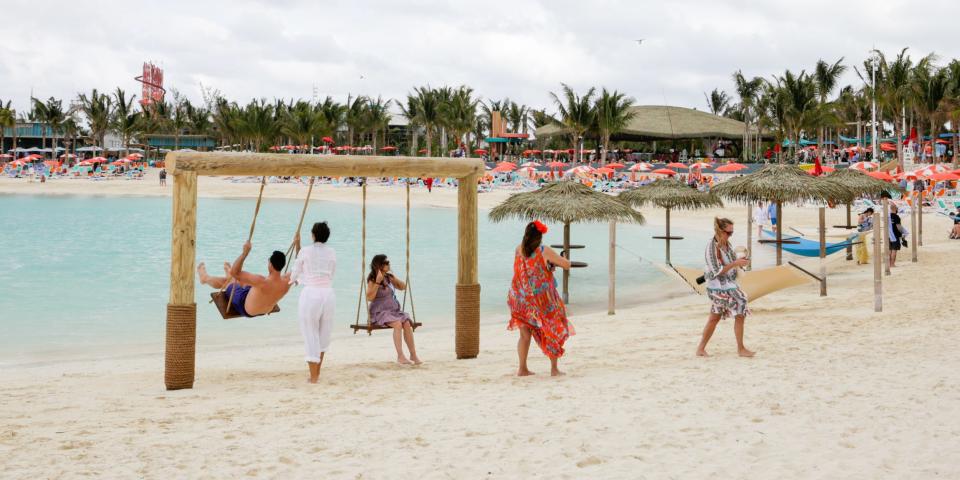 people walking and on swings at Royal Caribbean Perfect Day at CocoCay's Hideaway Beach