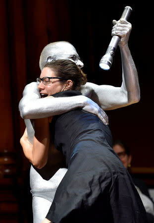 Emily Holman, of Cambridge, Mass., hugs Jim Bredt, the human spotlight, after winning "The Empty Box" prize during the 27th First Annual Ig Nobel Prize Ceremony at Harvard University in Cambridge, Massachusetts, U.S. September 14, 2017. REUTERS/Gretchen Ertl