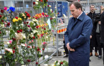 FILE PHOTO: Swedish Prime Minister Stefan Lofven looks at flowers laid for the victims as he visits the crime scene, April 8, 2017, the day after a hijacked beer truck plowed into pedestrians on Drottninggatan and crashed into Ahlens department store, in central Stockholm, Sweden. TT News Agency/Jonas Ekstromer via REUTERS /File Photo