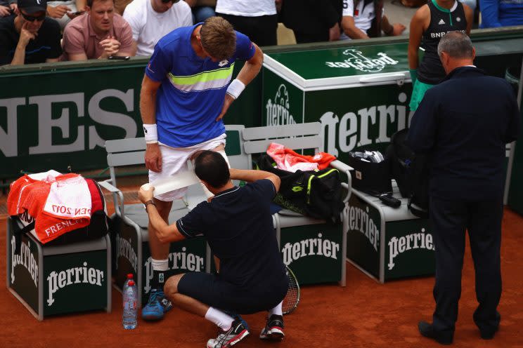 South African tennis player Kevin Anderson receives treatment and support for an injury in the third round of the French Open. Injuries ultimately forced Anderson to resign from the tournament one match later. (Getty Images)