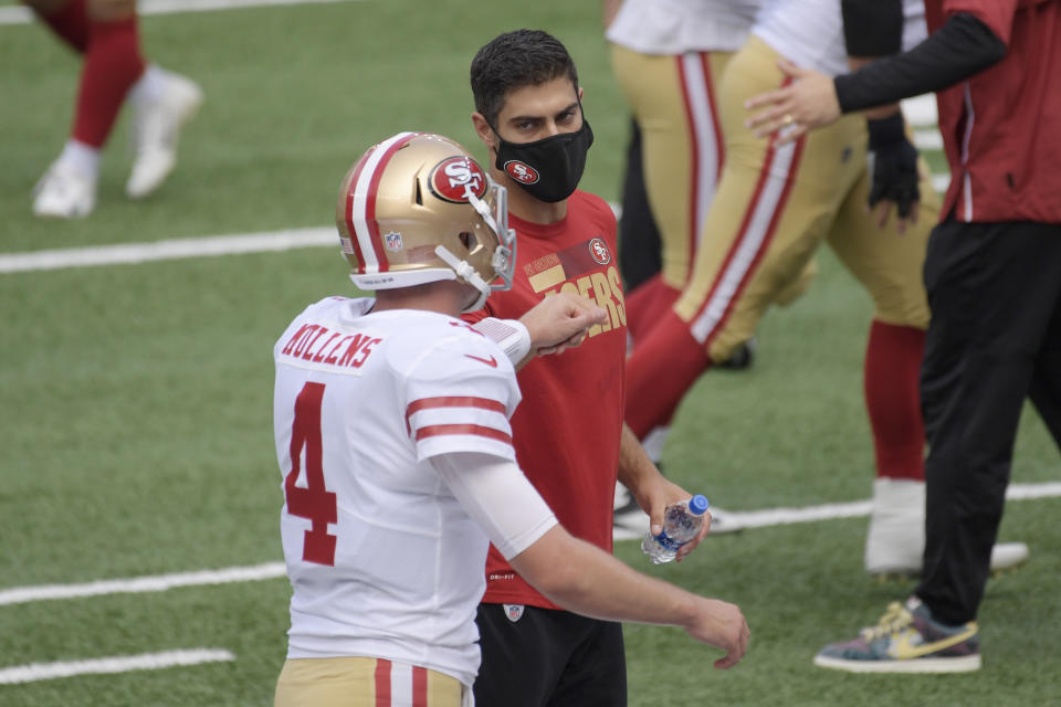 San Francisco 49ers quarterback Jimmy Garoppolo, right, greets quarterback Nick Mullens during warm-ups before an NFL football game against the New York Giants, Sunday, Sept. 27, 2020, in East Rutherford, N.J. (AP Photo/Bill Kostroun)