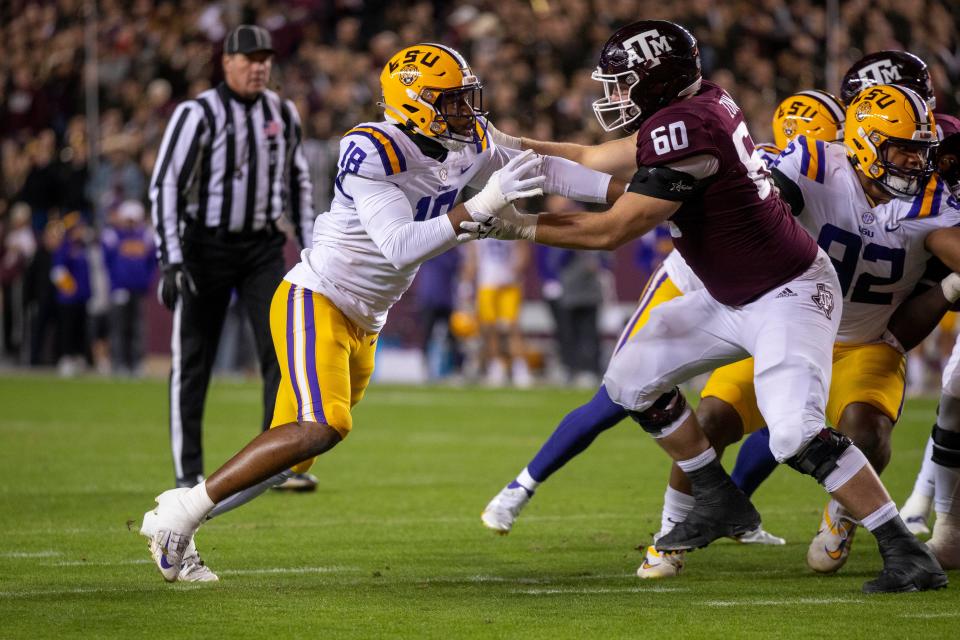 Nov 26, 2022; College Station, Texas, USA; LSU Tigers defensive end BJ Ojulari (18) and Texas A&M Aggies offensive lineman Trey Zuhn III (60) in action during the game between the Texas A&M Aggies and the LSU Tigers at Kyle Field.