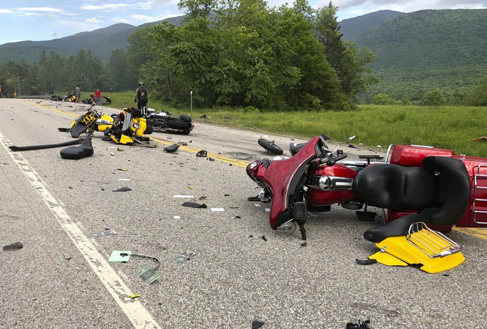 This photo provided by Miranda Thompson shows the scene where several motorcycles and a pickup truck collided on a rural, two-lane highway Friday, June 21, 2019 in Randolph, N.H. New Hampshire State Police said a 2016 Dodge 2500 pickup truck collided with the riders on U.S. 2 Friday evening. The cause of the deadly collision is not yet known. The pickup truck was on fire when emergency crews arrived. (Miranda Thompson via AP)