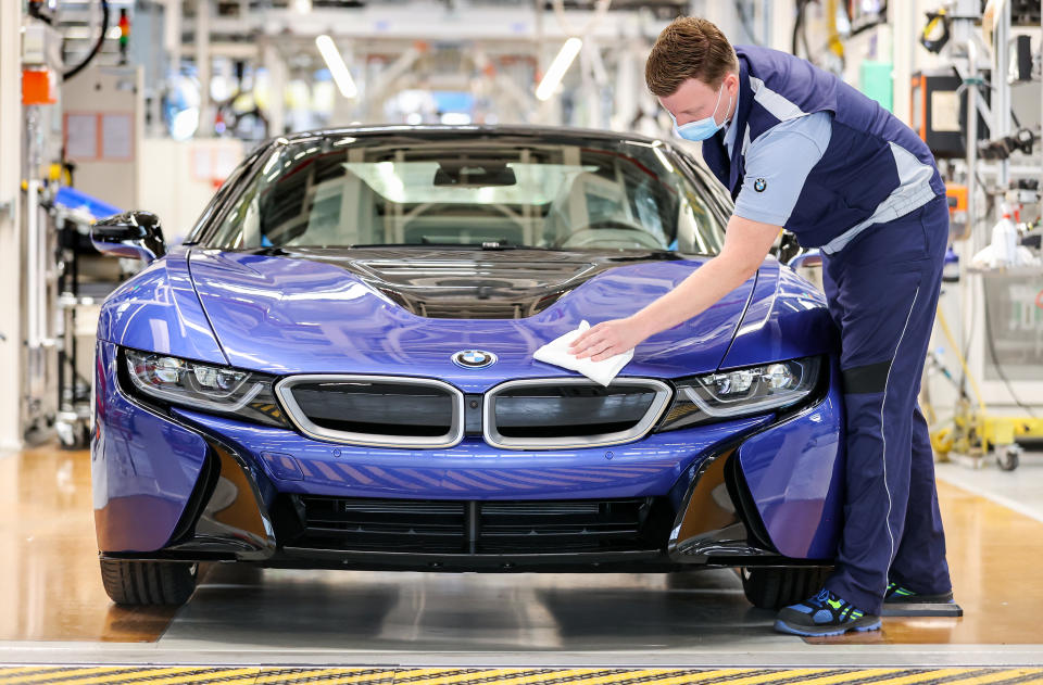 11 June 2020, Saxony, Leipzig: At the end of the production line, an employee walks over the last BMW i8 with a cloth. Six years after its market launch, the last plug-in hybrid sports car has rolled off the assembly line here. A total of 20 488 of these cars were produced at the Leipzig plant. This makes the hybrid sports car with electric and gasoline engines by far the best-selling sports car at BMW. The vehicle with a passenger cell made of carbon-reinforced plastic (CFRP) won numerous awards. In addition to vehicles with combustion engines, BMW also builds the electric model i3 in Leipzig. Photo: Jan Woitas/dpa-Zentralbild/dpa (Photo by Jan Woitas/picture alliance via Getty Images)