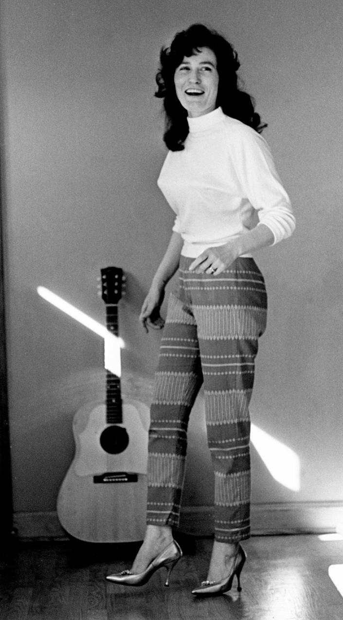 Loretta Lynn shows how she had to practice walking in high heel shoes Jan. 31, 1962, before she could run onto the Grand Ole Opry stage without stumbling. The singer prefers boots, but the Wilburn Brothers insisted she wear high heels.