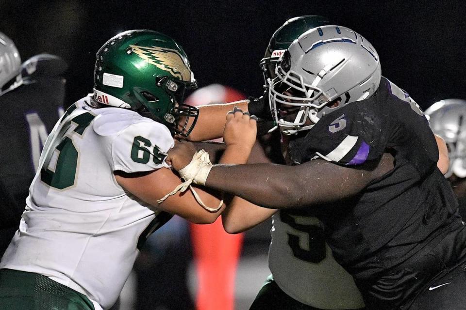 South Garner’s Nnamdi Ogboko blocks Enloe’s William Almeida (66) during the second half. The Enloe Eagles and the South Garner Titans met in a non-conference game in Wake Forest, N.C. on September 8, 2023.