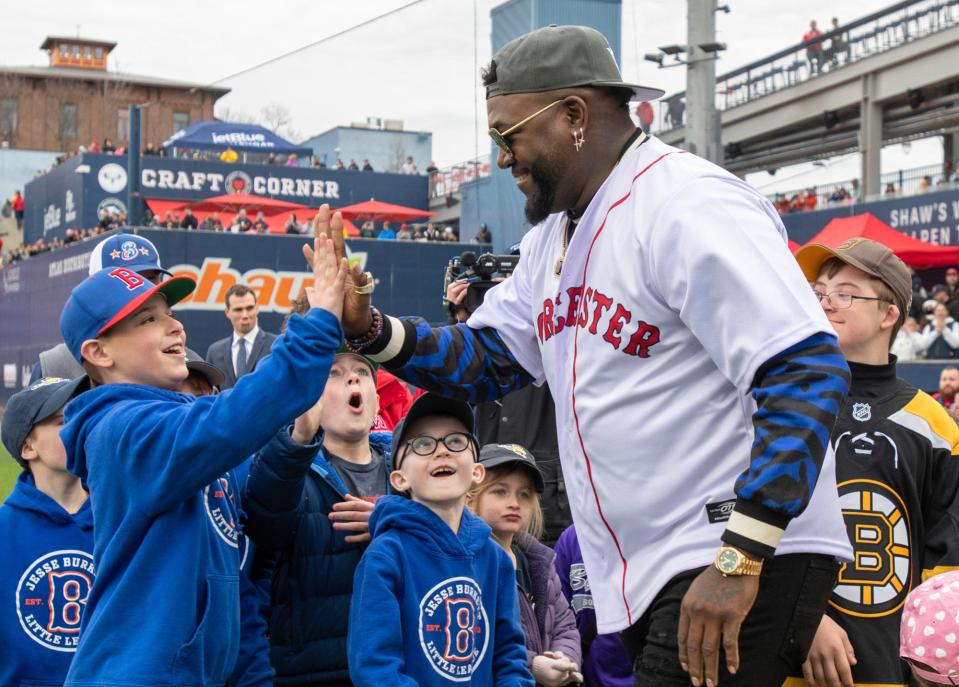 Boston Red Sox legend David Ortiz is greeted by Jesse Burkett Little League players as he enters the field at Polar Park.