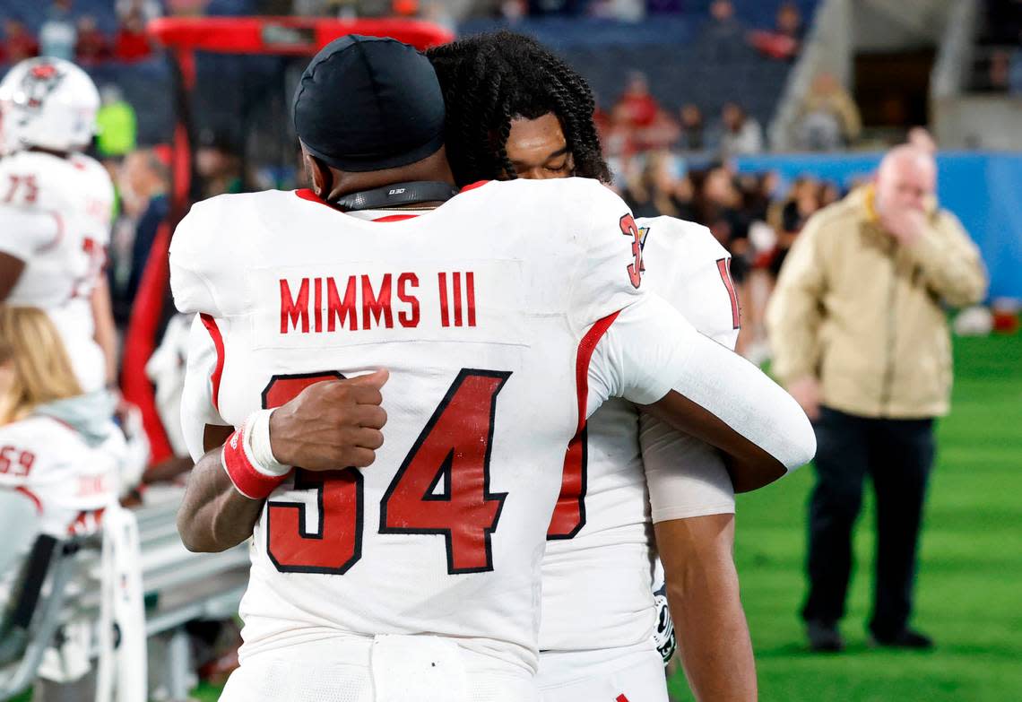 N.C. State’s KC Concepcion (10) and Delbert Mimms III (34) hug late in the fourth quarter during the second half of Kansas State’s 28-19 victory over N.C. State in the Pop-Tarts Bowl at Camping World Stadium in Orlando, Fla., Thursday, Dec. 28, 2023. Ethan Hyman/ehyman@newsobserver.com