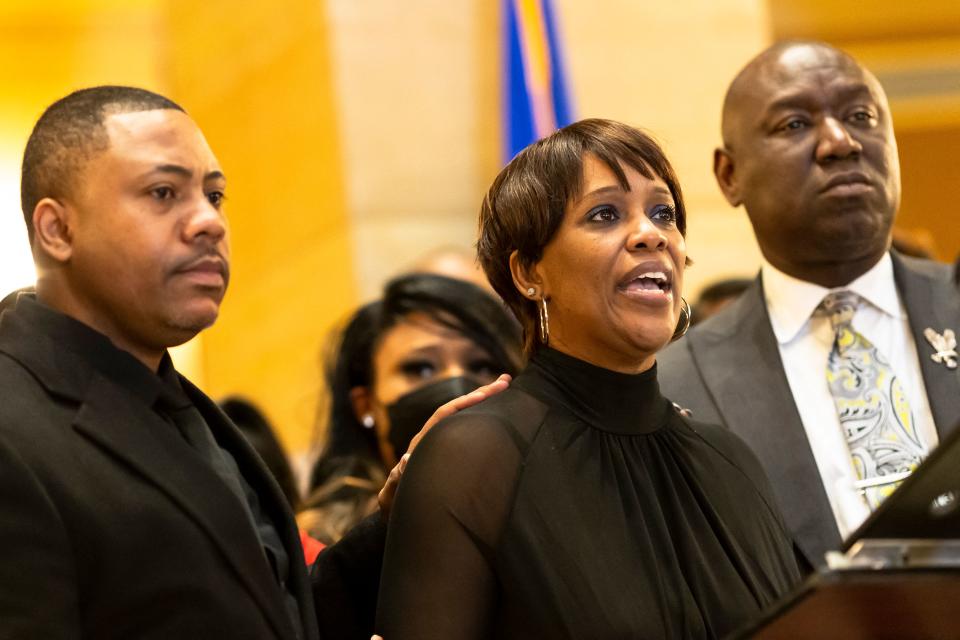 Civil rights attorney Ben Crump, right, with Amir Locke's parents, Andre Locke and Karen Wells 